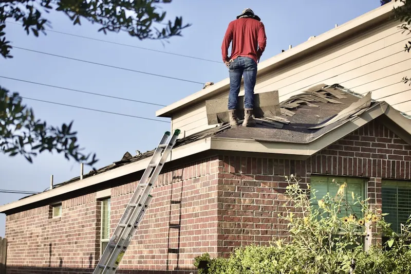 Professional roofer working on a residential roof in East Spencer
